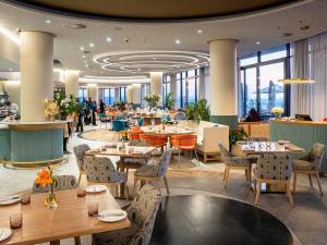 a restaurant with tables and chairs and people in the background at 2115 Kepler, Ellipse - Serene Luxury in Midrand