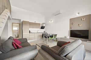 a living room with two couches and a tv at Apartments Jana & Paula in Cres