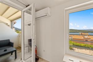 a room with a large window with a view at Apartments Jana & Paula in Cres