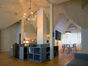 a kitchen and dining room with a chandelier in a room at Katrina Apartment in Kuldīga
