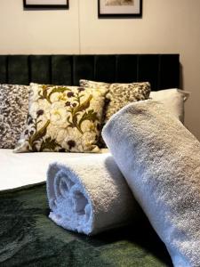a towel sitting on top of a bed with pillows at BV Aparthotel Castleford Perfect for Cooperate and Leisure Stays in Castleford