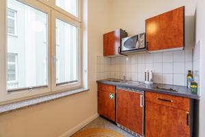 a kitchen with a sink and a microwave at Apartment mit Traveblick in Lübeck