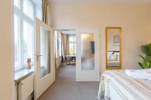 a bedroom with a bed and a dining room at Apartment mit Traveblick in Lübeck