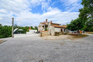 een huis op een grindweg met een huis bij Apartment Lara with Swimming Pool - Paradiz in Veli Turini +24 foto's