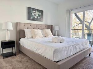 a bedroom with a large bed with two towels on it at Luxury New 1B1B Private Balcony w Dryer Washer 525Pkwy in Atlanta