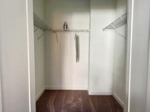 an empty room with white walls and a closet at Luxury New 1B1B Private Balcony w Dryer Washer 525Pkwy in Atlanta