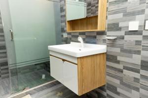 a bathroom with a sink and a shower at Firnic Luxurious Private Hotel in Accra