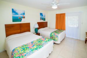 a hotel room with two beds and a fan at Sugar Bay Club in Frigate Bay +48 photos