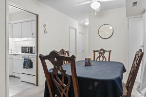a dining room with a table and chairs and a clock at Your perfect stay - Cozy 2BR apartment in NOVA in Arlington