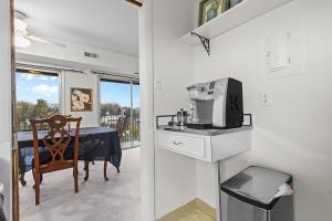 a small kitchen with a table and a microwave at Your perfect stay - Cozy 2BR apartment in NOVA in Arlington