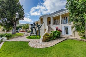 a house with a statue in front of it at The Moko Jumbie House - Premier Suite in Christiansted