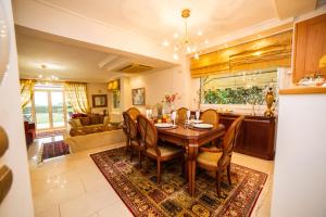 a kitchen and living room with a wooden table and chairs at 2K Eco Villa in Plagiárion