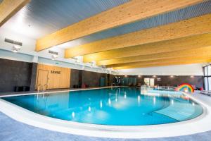 a large swimming pool in a large building at Hotel Sport - Terme Krka in Otočec