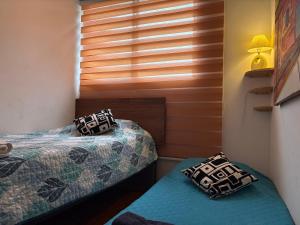 Postel nebo postele na pokoji v ubytování Amazing view of Santiago con Aire acondicionado y parking + 19 fotografií