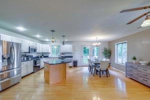 a large kitchen with white cabinets and a dining table at Linden Family Home with Yard Less Than 5 Mi to Wineries! in Front Royal