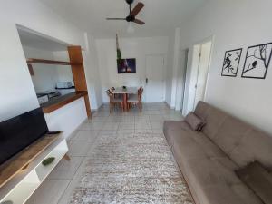 a living room with a couch and a table at Ap sossegado na Praia do Canto in Vitória +24 photos