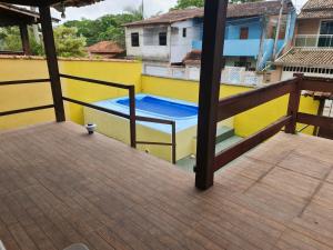 a balcony with a pool on a yellow building at Casa da Acerola in Rio das Ostras +26 photos
