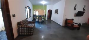 a living room with two chairs and a couch at Casa da praia, Caraguatatuba in Caraguatatuba