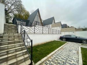 a car parked in front of a house with stairs at Aframe New in Uçgün