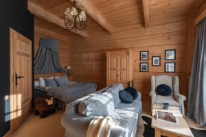 a living room with a couch and a bed at Willa Rajka in Zakopane