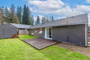 a house with a wooden deck in the yard at Dog Friendly Cozy Remodeled Shoreline Rambler in Shoreline