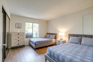 a bedroom with two beds and a window at Golf, Hike and Relax Cathedral City Condo in Cathedral City +23 photos