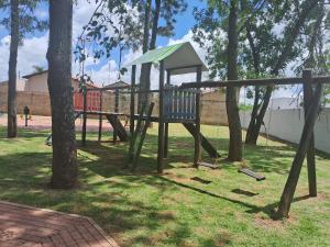 un parco giochi in un parco con un albero di Casa Agradável próxima ao Bosque a Porto Feliz