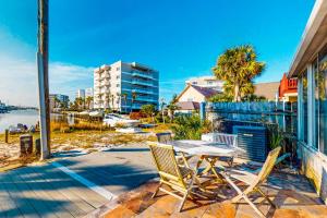 a table and two chairs on a patio with a view of the water at Southern Sunsets in Destin