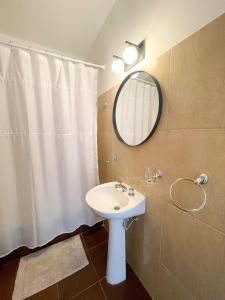 a bathroom with a sink and a mirror at Saavedra 118 8F by depptö in Bahía Blanca