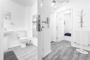 a white bathroom with a toilet and a sink at Middle Meadow 2 bedroom Modern Apartment Sleeps 3 Contractors Families in Tipton +30 photos