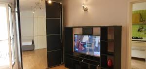 a living room with a tv in a black entertainment center at A casa di Giò e Lorenzo- Appartamento via Guidelli in Reggio Emilia