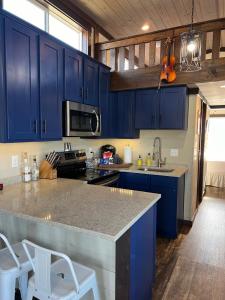a kitchen with blue cabinets and a counter top at Piney River Resort in Bon Aqua