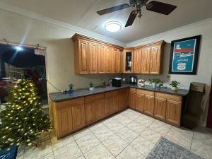 a kitchen with a christmas tree and wooden cabinets at Howard Johnson by Wyndham Bakersfield in Bakersfield