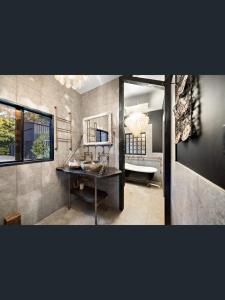 a bathroom with a sink and a mirror and a tub at Rakali Retreat in Cooran +21 photos