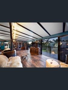 a large living room with a couch and a table at Rakali Retreat in Cooran