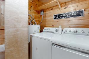 a laundry room with a white washer and dryer at Four Seasons Retreat in Townsend +19 photos