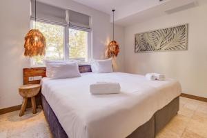 a large white bed in a room with a window at La Boheme - Adults Only in Obzor