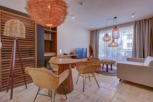 a living room with a table and chairs at La Boheme - Adults Only in Obzor