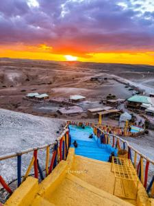 a view of a water park at sunset at La Dune Agafay Desert Camp in Marrakech