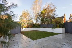 a backyard with a white fence and a yard at Host & Stay - Martinhoe in Yarm