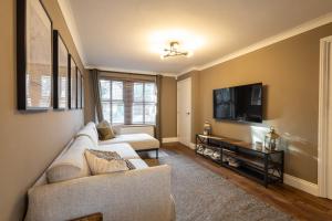 a living room with a couch and a tv at Host & Stay - Martinhoe in Yarm
