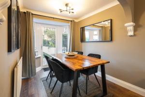 a dining room table with chairs and a mirror at Host & Stay - Martinhoe in Yarm +16 photos