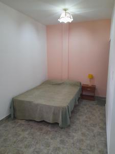 Una cama o camas en una habitación de Departamentos Niñas