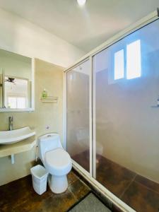 a bathroom with a toilet and a shower and a sink at Casa Coronaa Holbox México in Holbox Island +37 photos