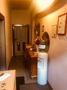 a room with a hallway with a counter and a refrigerator at Wohnung 40 Quadratmeter in Arnstein
