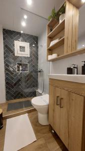 a bathroom with a toilet and a sink and a shower at 70 steps studio A, 50 meters from Dimokratias metro station in Thessaloniki