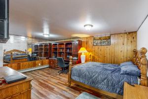 a bedroom with a bed and a desk at Red Deck Retreat in Anchorage