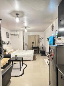 a living room with a bed and a table at Affordable Condo in Cebu in Cebu City