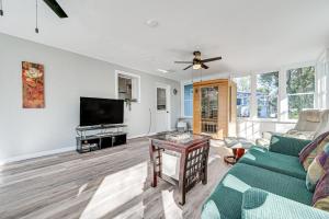 a living room with a couch and a tv at 6 Mi to Sponge Docks Lake Tarpon Getaway with Dock! in Palm Harbor
