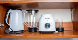 two appliances sitting on a wooden shelf at Cozy Haven in Juja